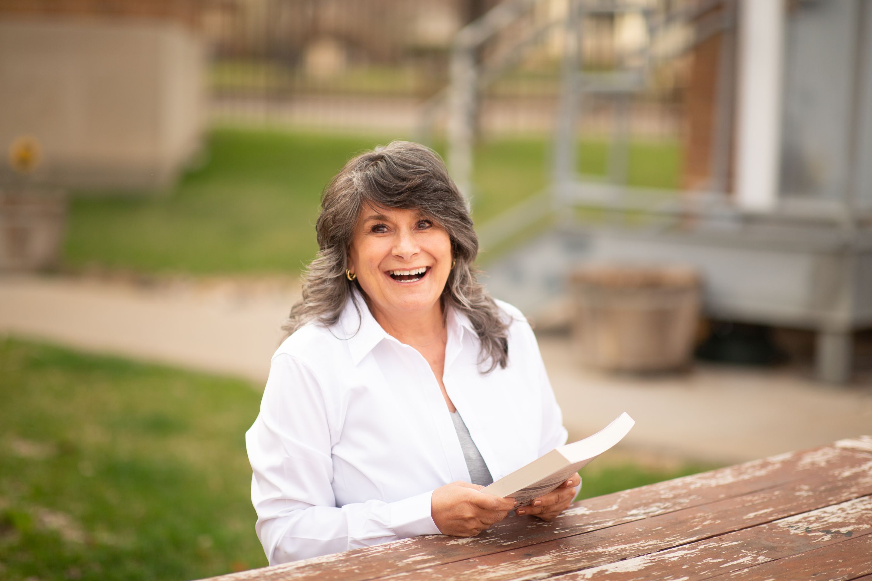 Author Renée E. Bryan holding The Morality of Money